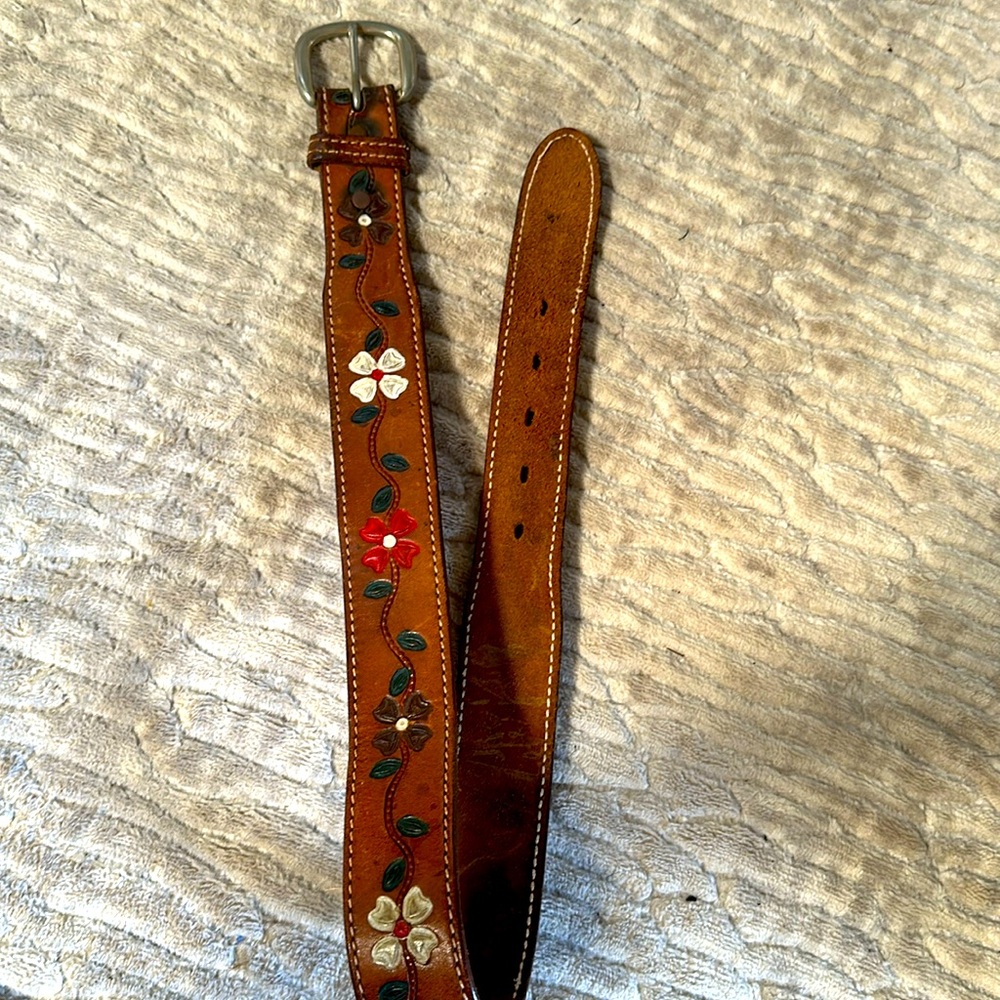 Genuine cowgirl leather belt with flower detail.